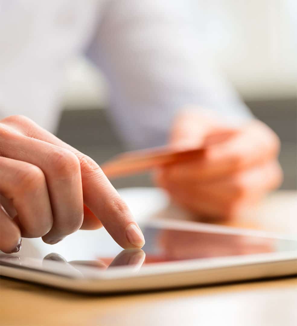 A woman paying her bills on a tablet